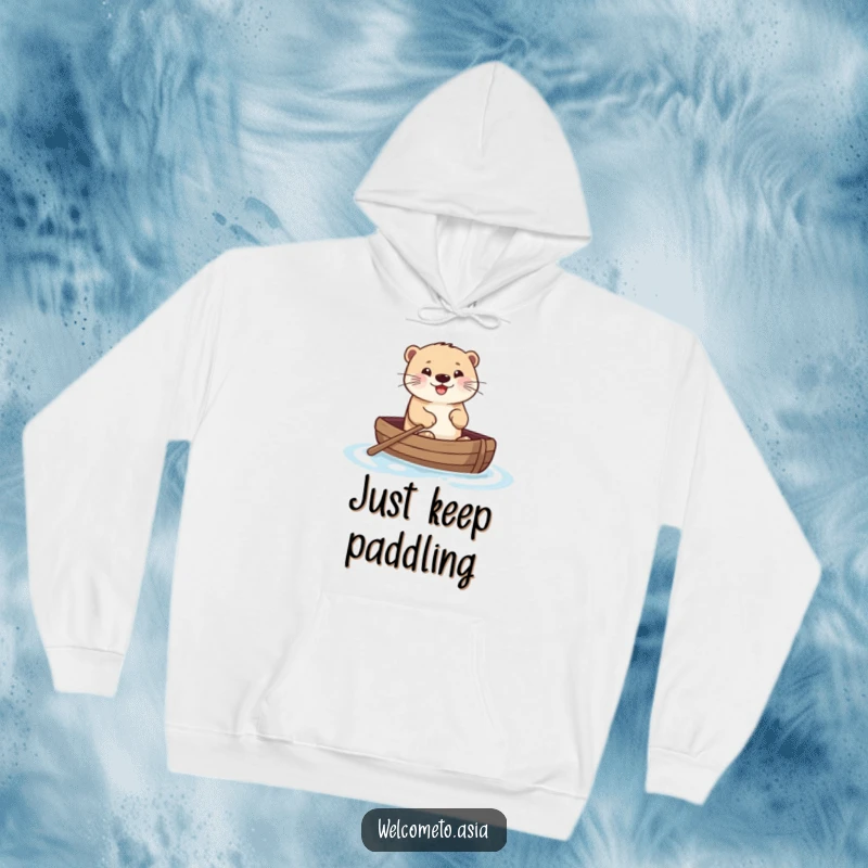 Funny hoodie displaying a smiling otter enthusiastically paddling a small boat on the water, presenting a scene of pure, joyful escapism.
