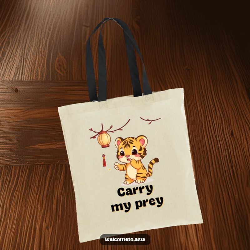 Funny Tiger Cub Tote Bag: A curious tiger cub playfully swats at a dangling lantern, bringing playful charm to your day.
